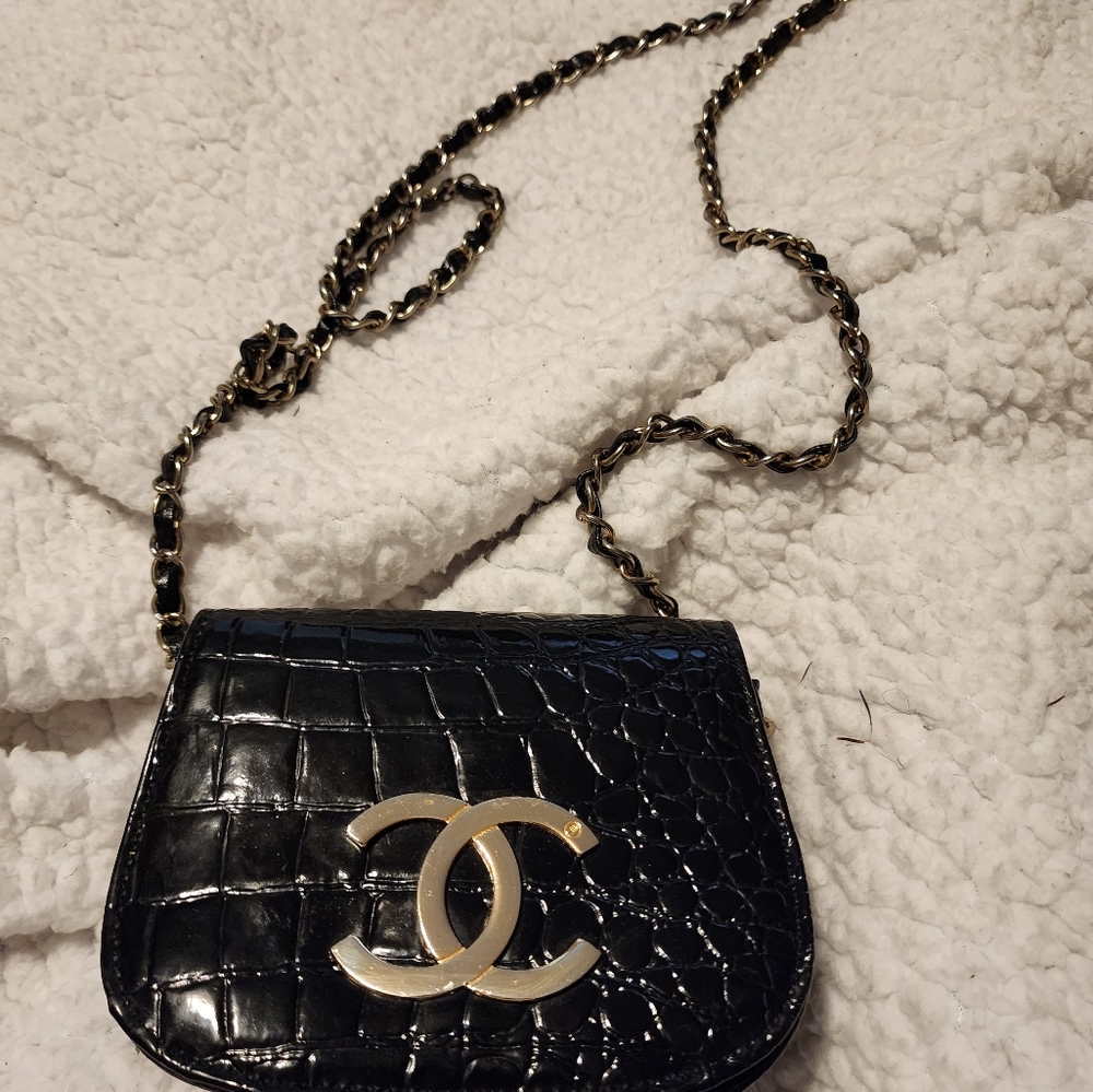 Chanel large CC emblem on front. Leather vintage black bag